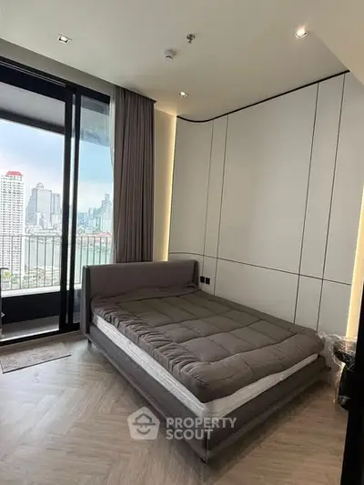 Modern bedroom with city view and balcony access in luxury apartment
