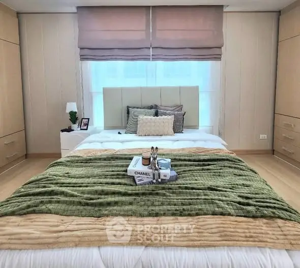 Luxurious bedroom with elegant decor and plush bedding in a modern apartment.