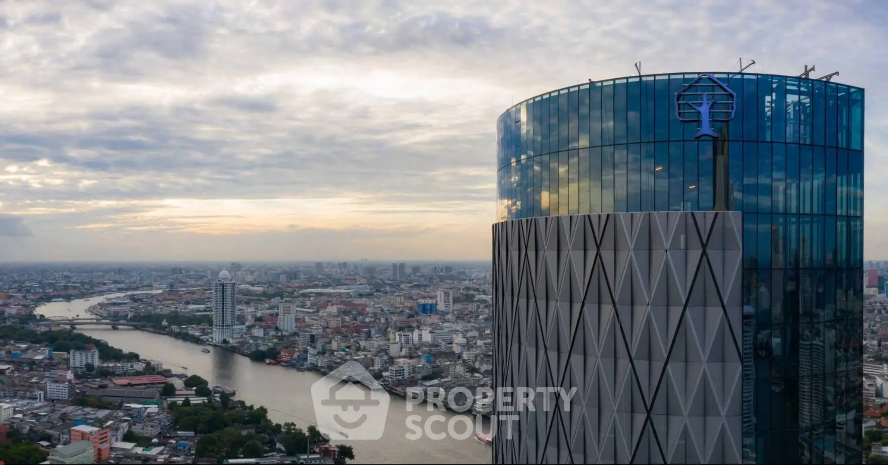 Stunning high-rise building with panoramic city and river views at sunset.
