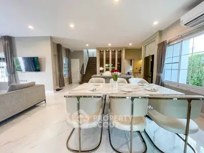 Luxurious open-plan living and dining area with modern furnishings and elegant decor.