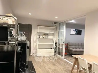 Modern open-plan living area with stylish furniture and wooden flooring