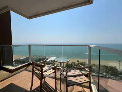 Stunning oceanfront balcony with panoramic sea views and modern seating.