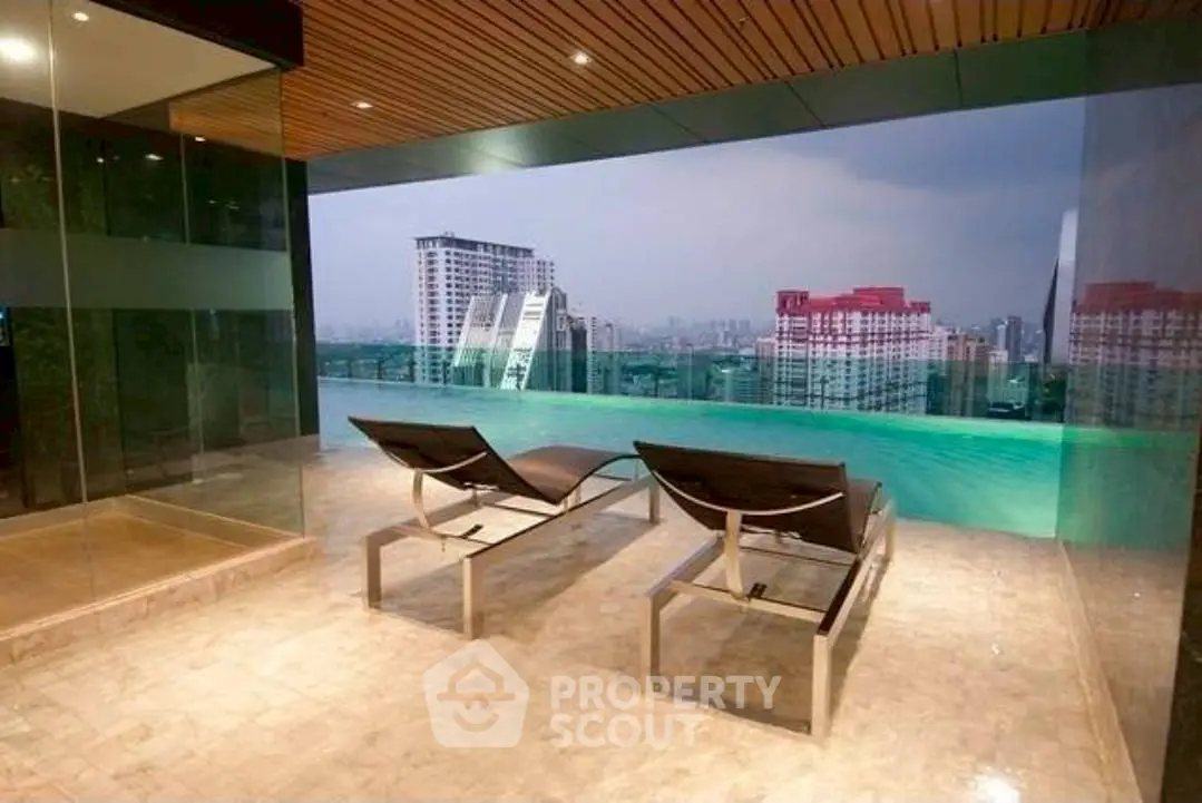 Luxurious rooftop pool with stunning city view and modern lounge chairs.