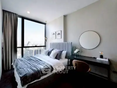 Modern bedroom with city view, stylish decor, and natural light.