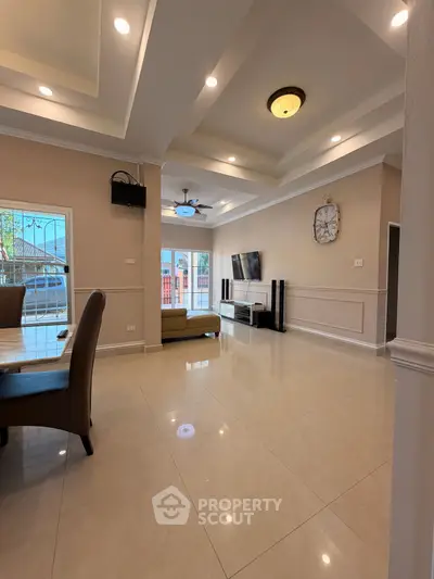 Spacious modern living room with elegant ceiling design and natural light