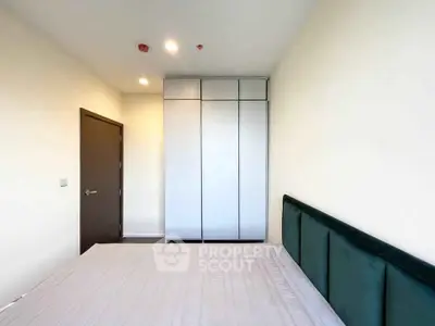 Modern bedroom with sleek wardrobe and minimalist design, perfect for urban living.