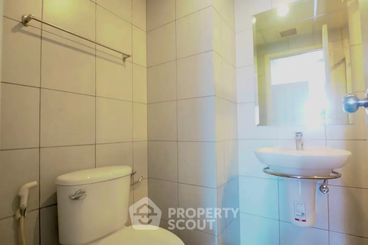 Modern bathroom with sleek fixtures and tiled walls