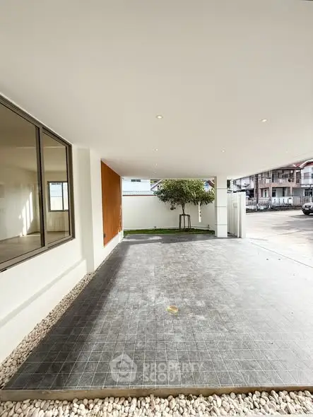 Spacious covered parking area with modern design and natural light