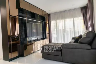 Modern living room with sleek entertainment center and plush sectional sofa