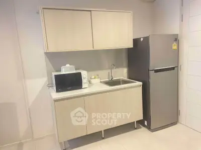 Compact kitchen with modern appliances and sleek cabinetry