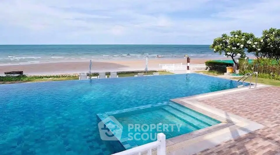 Luxurious beachfront pool with stunning ocean view, perfect for relaxation and leisure.