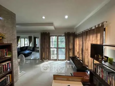 Spacious living room with modern decor and large windows for natural light.