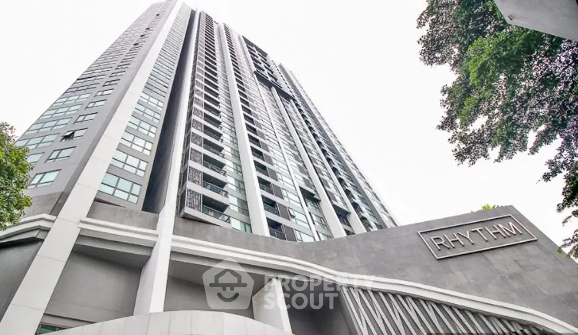 Modern high-rise building with sleek architecture and lush greenery