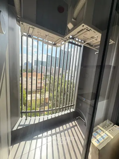 Modern balcony with city view and air conditioning units, perfect for urban living.