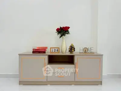 Elegant modern sideboard with decorative items in a stylish living room setting.