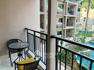 Charming balcony with pool view in modern apartment complex