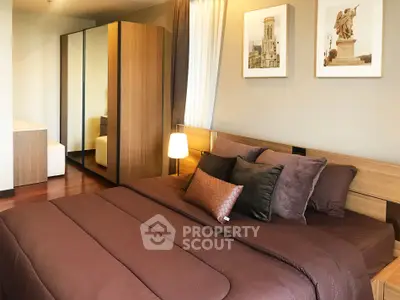 Luxurious bedroom with elegant decor and ample natural light, featuring a cozy bed and stylish wardrobe.