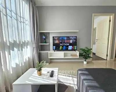 Modern living room with sleek TV setup and natural light
