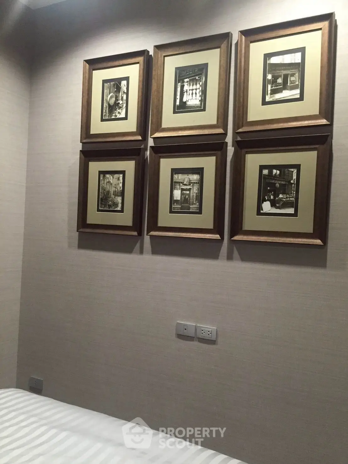 Cozy bedroom with elegant framed artwork and soft lighting