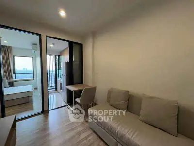 Modern apartment interior with cozy living room and bedroom view.