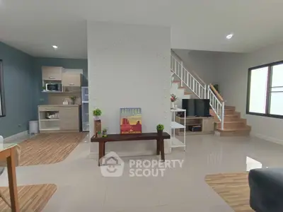 Spacious modern living room with open kitchen and stylish staircase