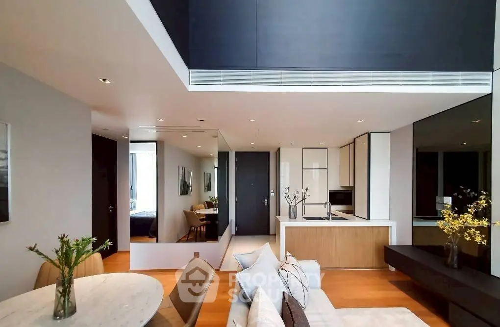 Modern open-plan living room with sleek kitchen and stylish decor