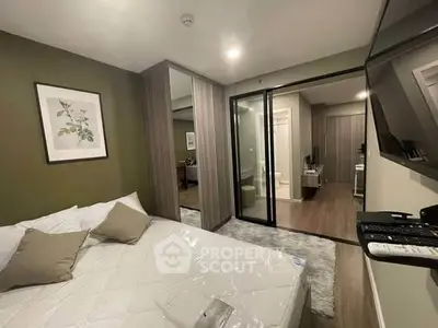 Modern bedroom with mirrored closet and stylish decor in a contemporary apartment.