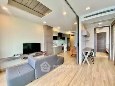 Modern open-layout living room with sleek kitchen and stylish furniture