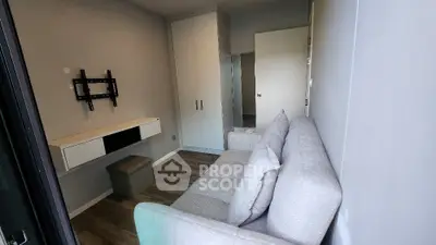 Cozy small living room with modern sofa and wall-mounted TV stand