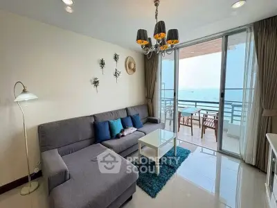 Spacious living room with modern decor and stunning sea view balcony.