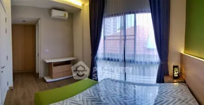 Modern bedroom with large window and stylish decor in urban apartment