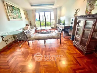 Spacious living room with elegant wooden flooring and stylish furniture, offering a cozy and inviting atmosphere.