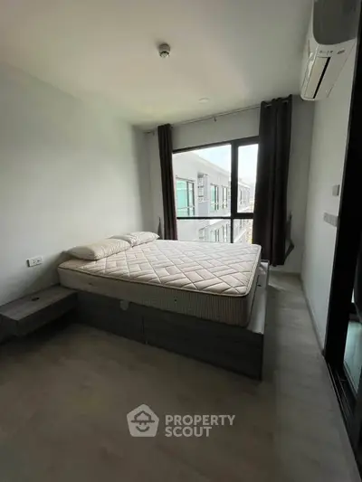 Modern bedroom with large window and minimalist design in urban apartment