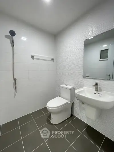 Modern bathroom with sleek white tiles and contemporary fixtures