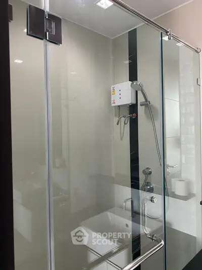 Modern bathroom with glass shower enclosure and sleek fixtures