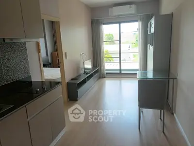 Modern apartment interior with open layout and large window view