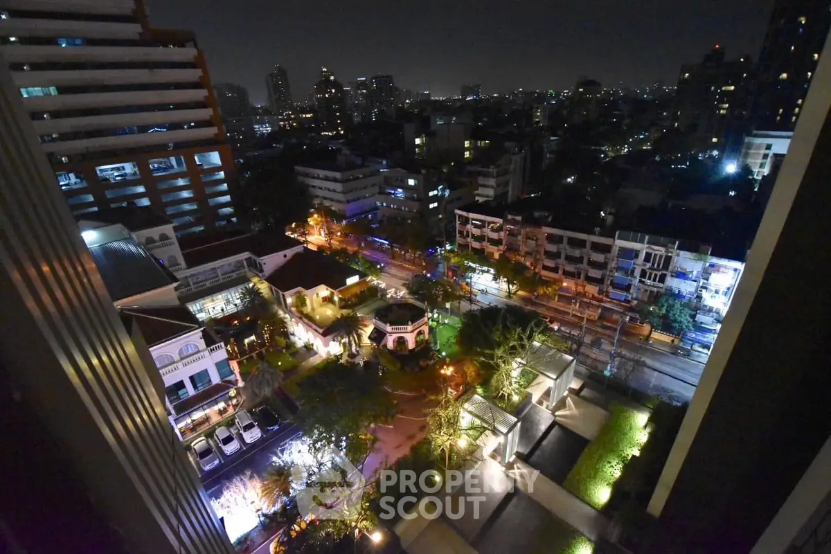 Stunning nighttime cityscape view from high-rise building balcony, showcasing vibrant urban lights and skyline.