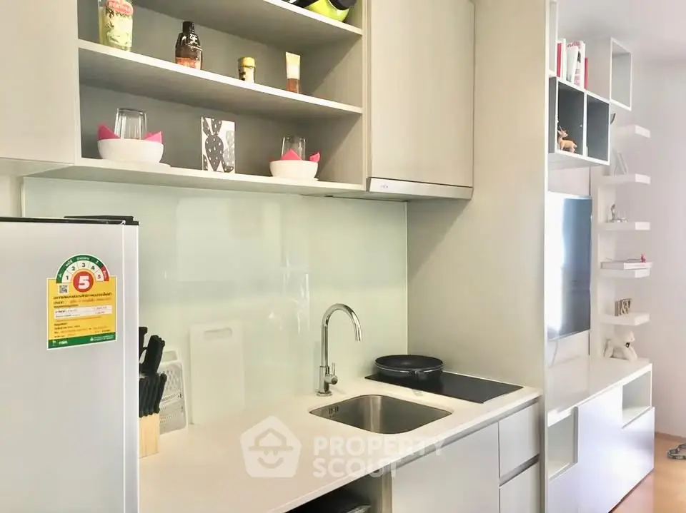 Modern kitchen with sleek cabinetry and integrated appliances in a stylish apartment.