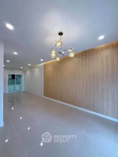 Spacious modern living room with elegant lighting and sleek tile flooring