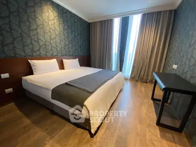 Spacious modern bedroom with elegant decor and large windows