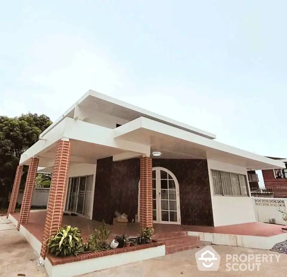 Modern single-story house with unique architectural design and spacious outdoor area.