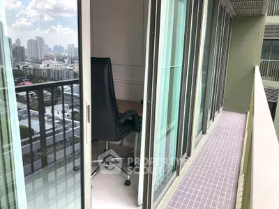 Modern high-rise balcony with city view and office chair, perfect for urban living.