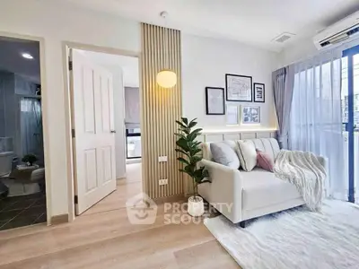 Modern living room with cozy sofa, stylish decor, and natural light from large window.