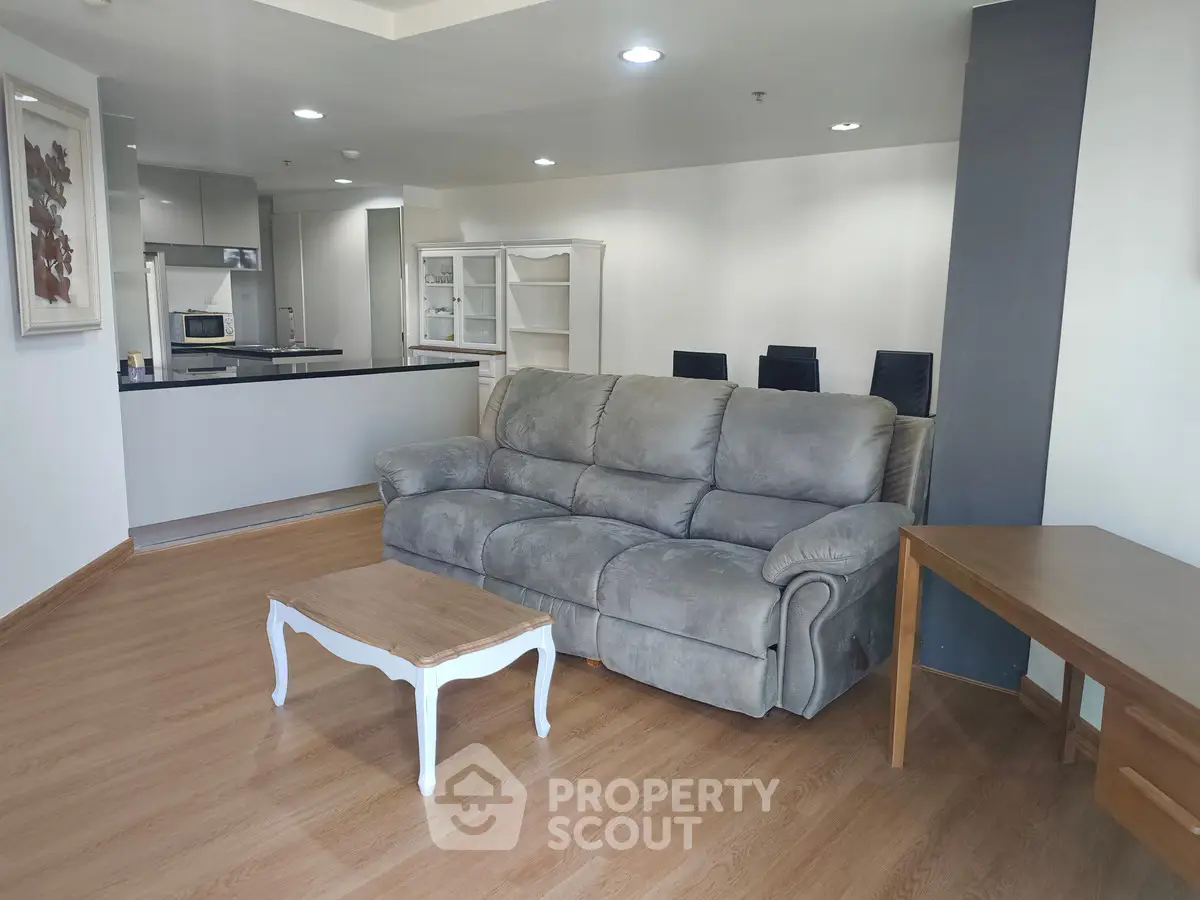 Spacious living room with modern kitchen and cozy seating area