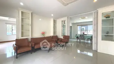 Spacious living room with modern furniture and dining area in open layout