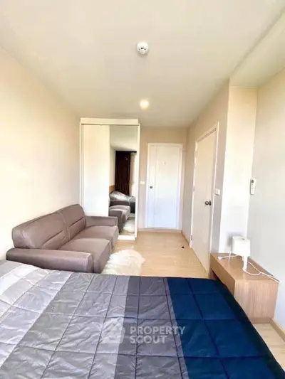 Modern bedroom with cozy sofa and stylish decor