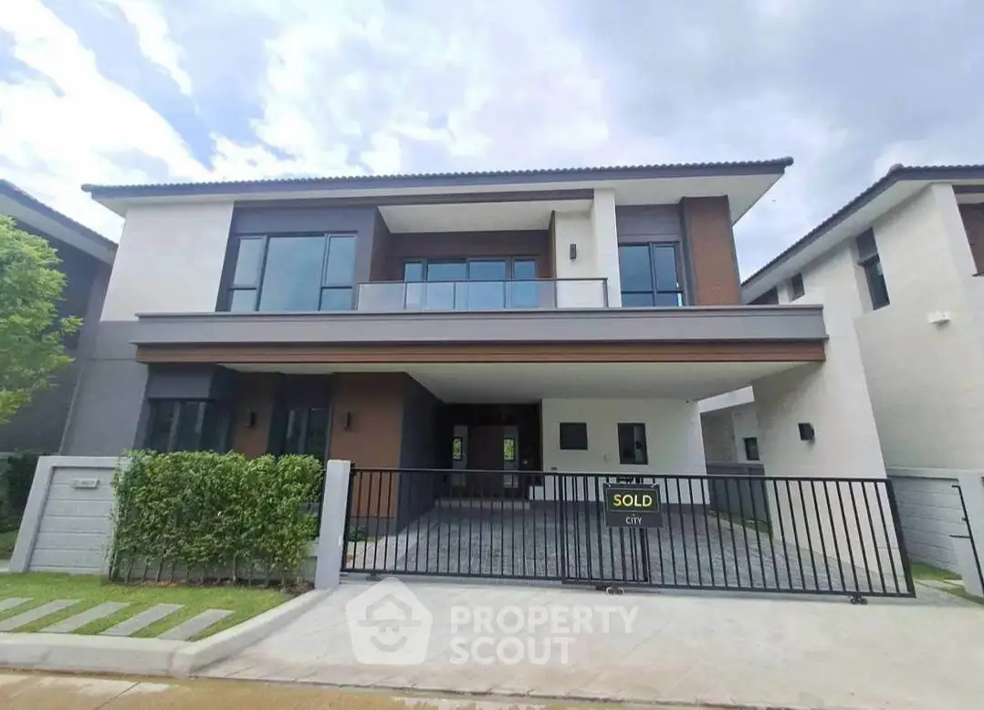 Modern two-story house with sleek design and spacious driveway in a serene neighborhood.