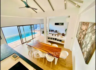 Stunning open-plan living room with pool view and elegant dining area in modern home.