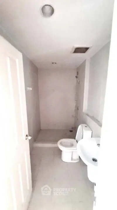 Spacious minimalist bathroom with modern fixtures and neutral tiles