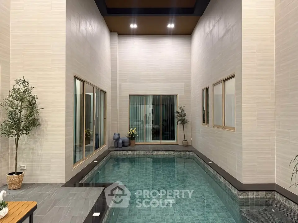 Luxurious indoor pool with elegant tile design and modern decor